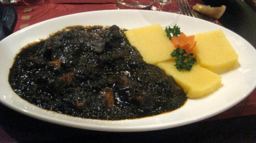 Cuttlefish in ink sauce with polenta, at Vino Vino in Venice